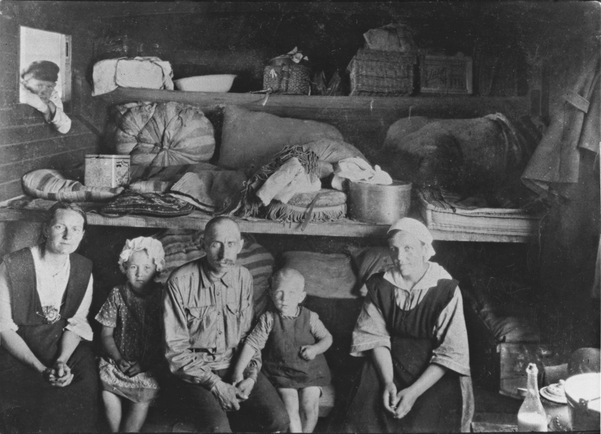 An old black and white photo of people sitting in a room